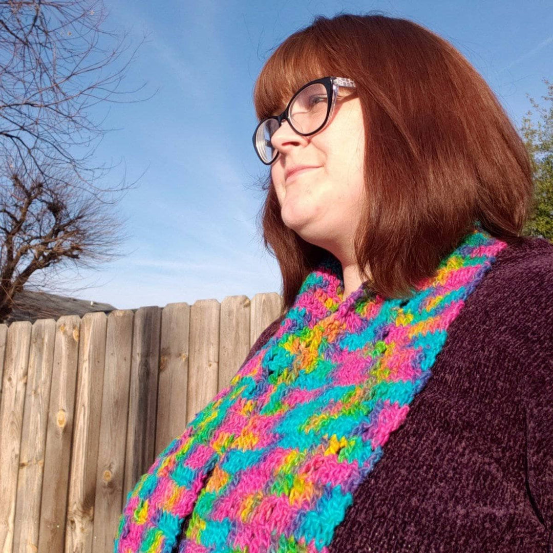 woman wearing the colorful Graduating Diamonds Crochet Scarf