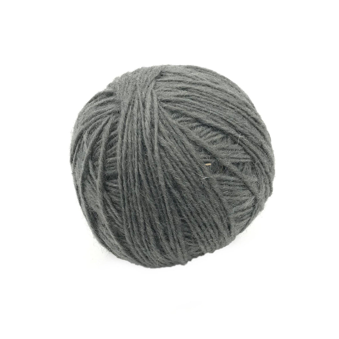 gray yarn cake over a white background