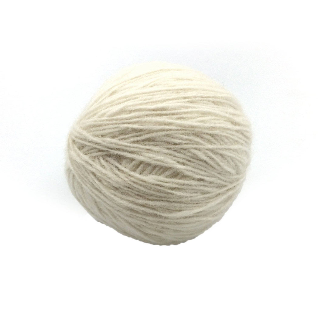 white yarn cake over a white background
