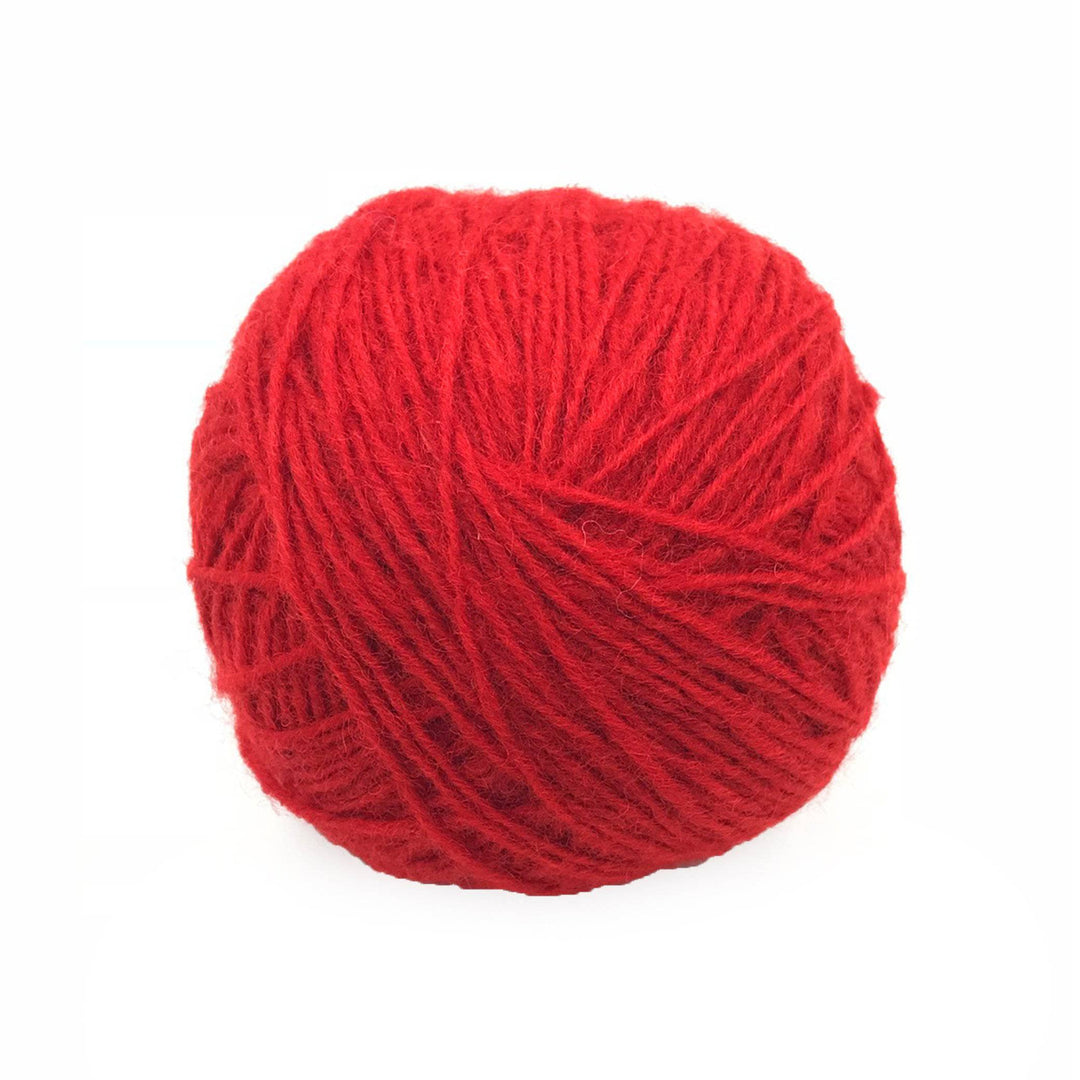 red yarn cake over a white background