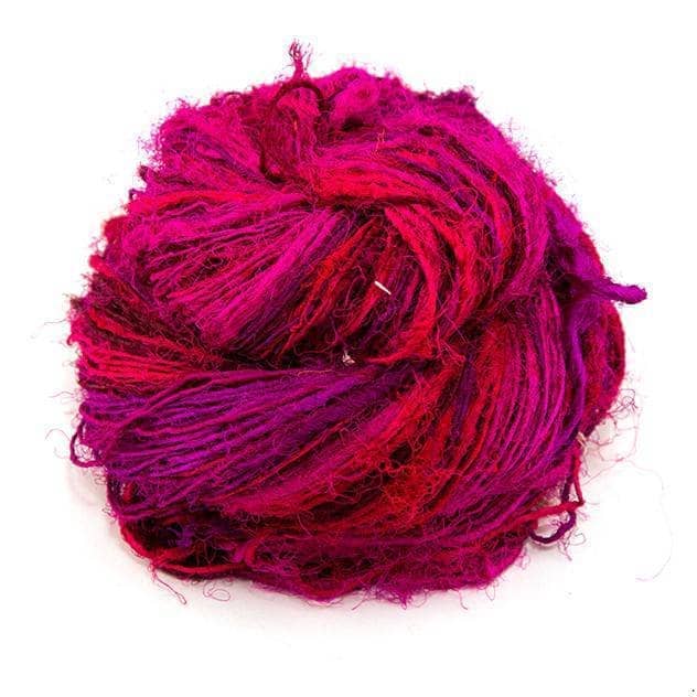 Handspun Sport Weight Recycled Silk Yarn over a white background