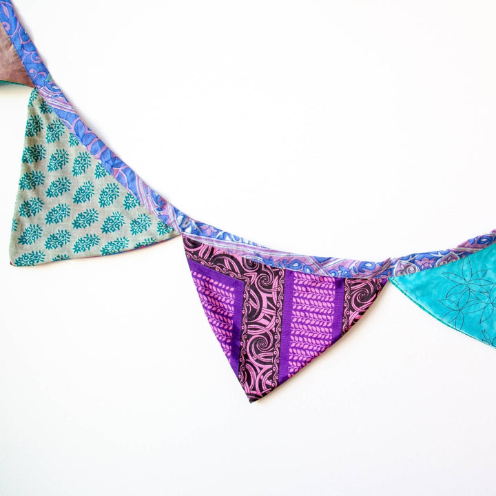 Handmade Recycled Sari Silk Bunting Banner hanging in a white wall