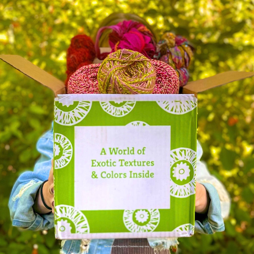 A woman standing outside holding a harvest editor's box in front of her face.
