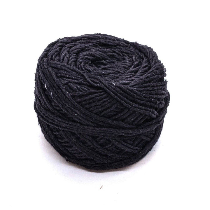 single skein of silk roving worsted weight in black in front of a white background.