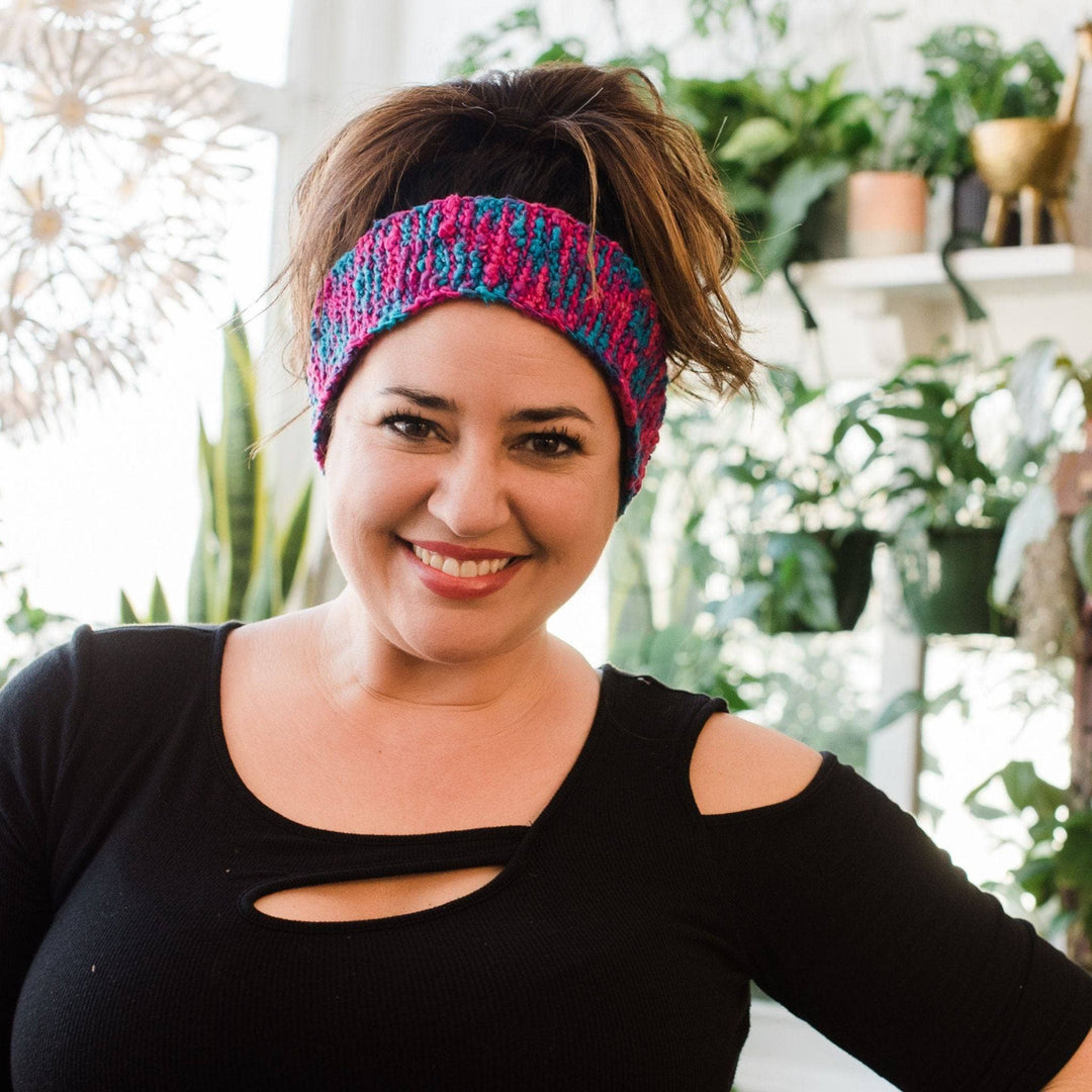 Model wearing delicious headband on head with potted greenery in the background.