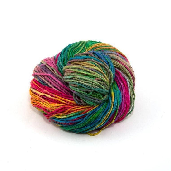 Single skein of silk roving worsted weight watercolors in front of a white background. 