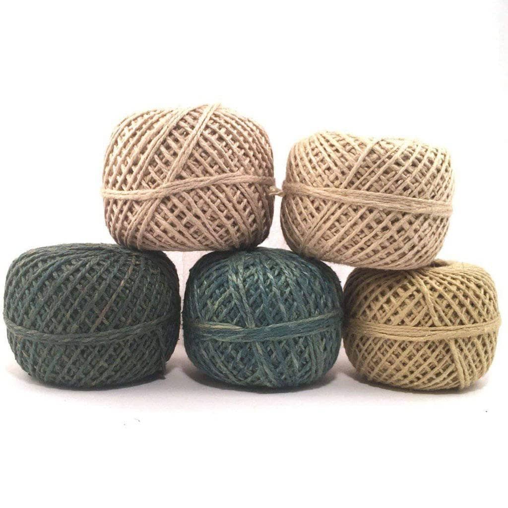 five yarn cakes of different colors