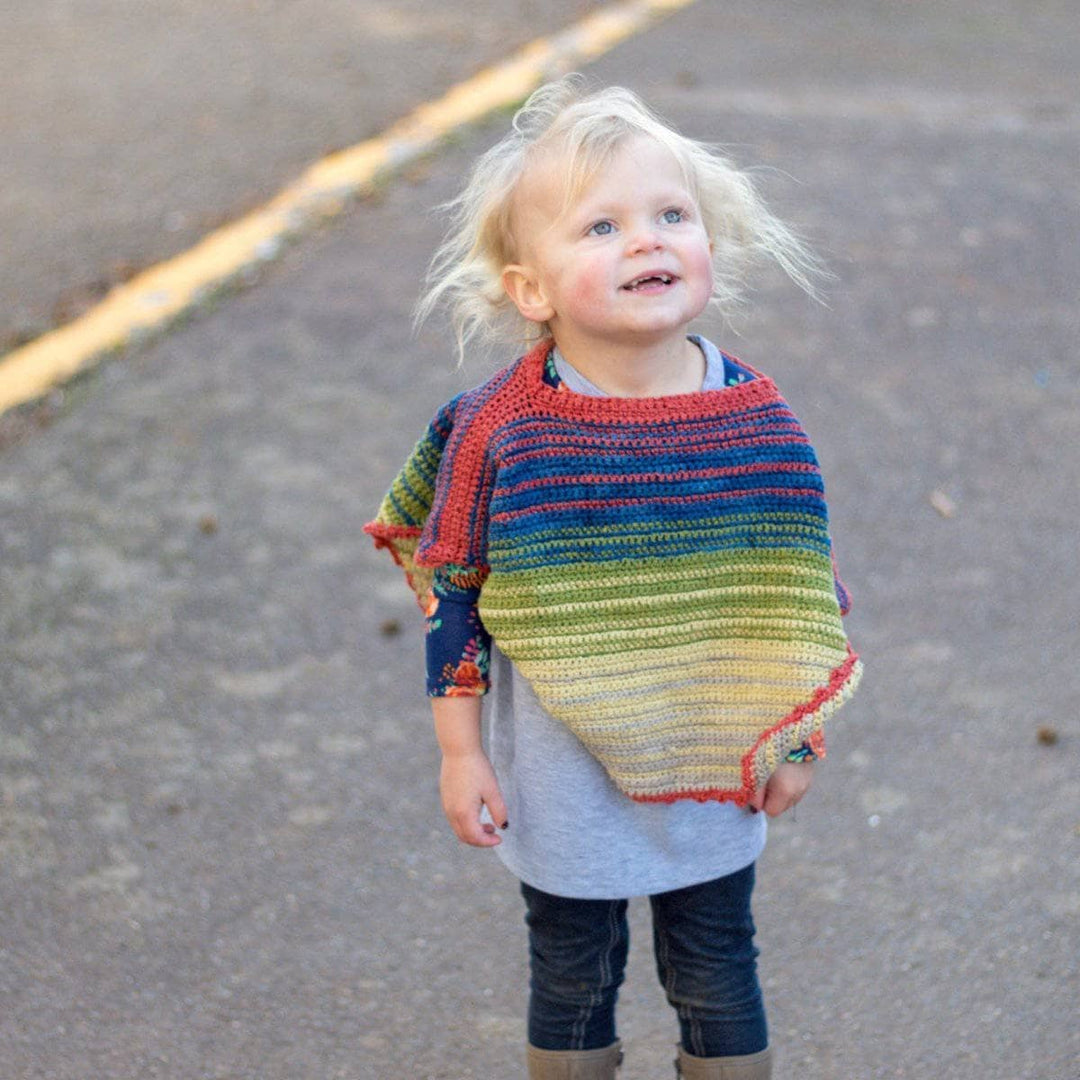 Toddler wearing a Herbal Dyed Silk Toddler Poncho outdoors