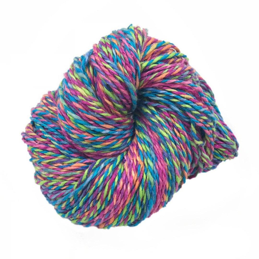 A pink and blue based multicolored skein of yarn on a white background