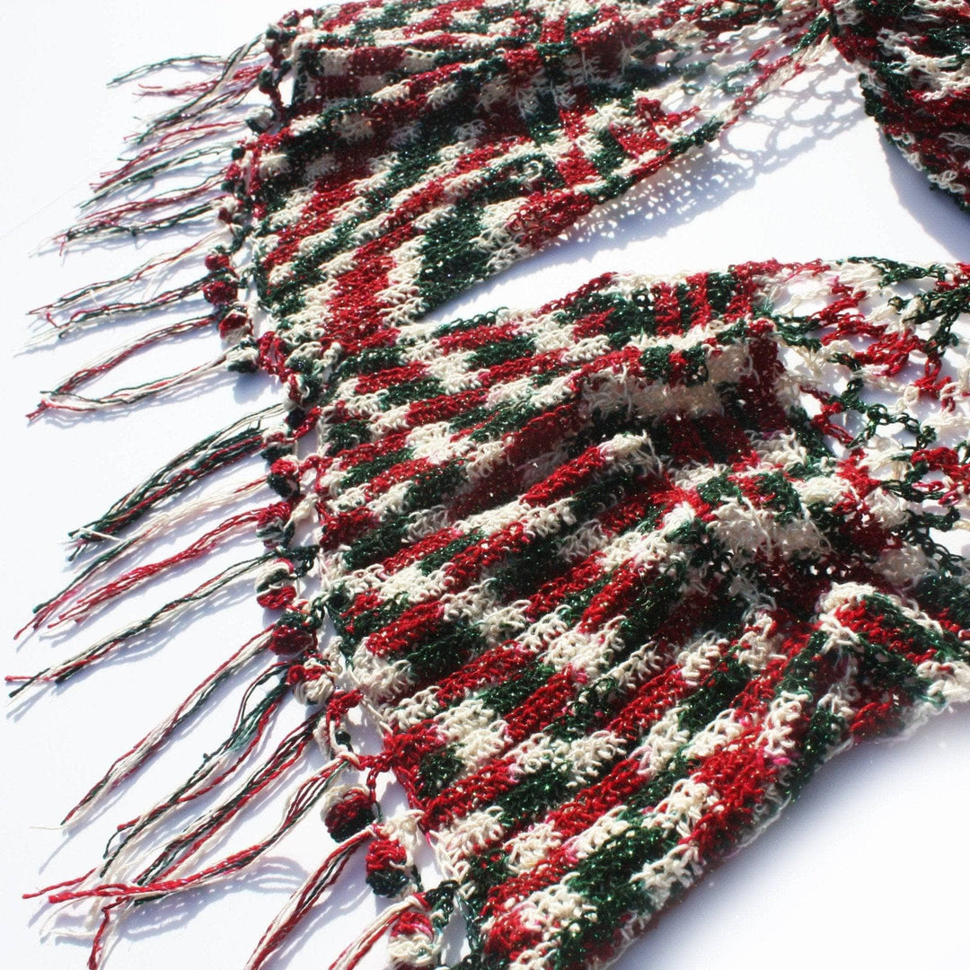 A red, green and white sparkle scarf on a white background
