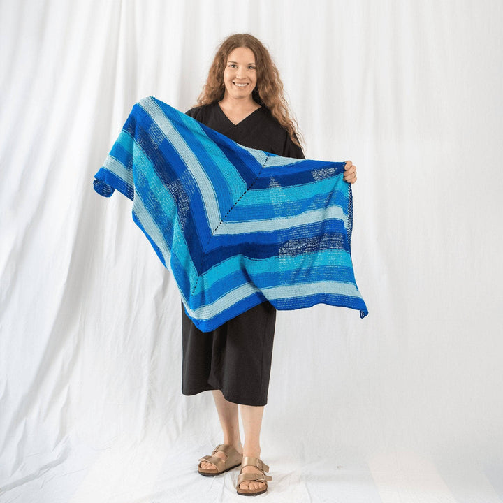 founder Nicole holding I'm feeling plucky tunisian crochet shawl in front of a white background.