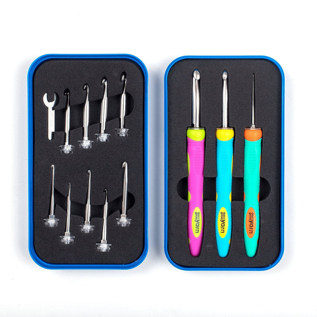 interchangeable crochet hook set in black foam inside blue case in front of a white background. 3 colorful ergonomic crochet hook handles with hooks attached, 9 hook attachments, and one wrench.