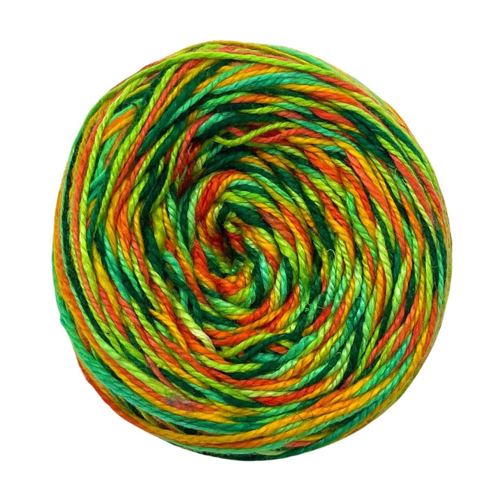 A skein of Journey Weight reclaimed silk yarn called Unbe-leaf-able on a white background.
