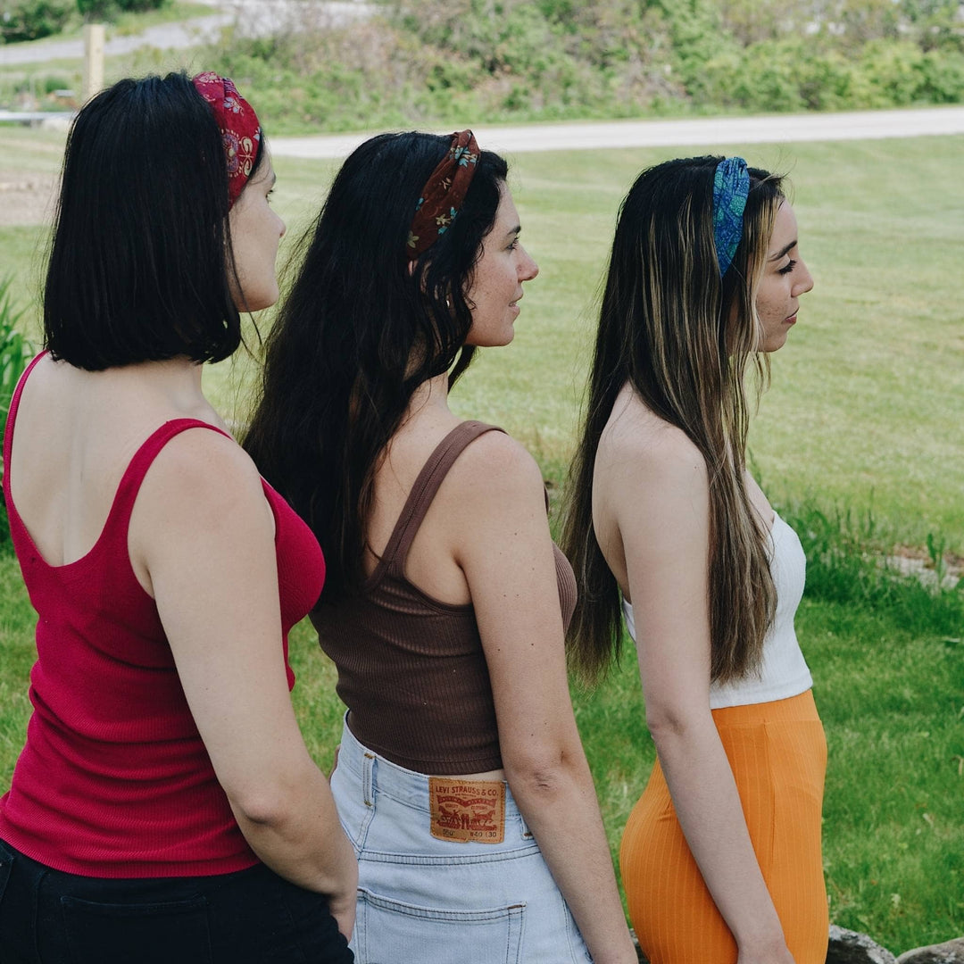 three models wearing assorted Kameela Knot Headband while standing outside