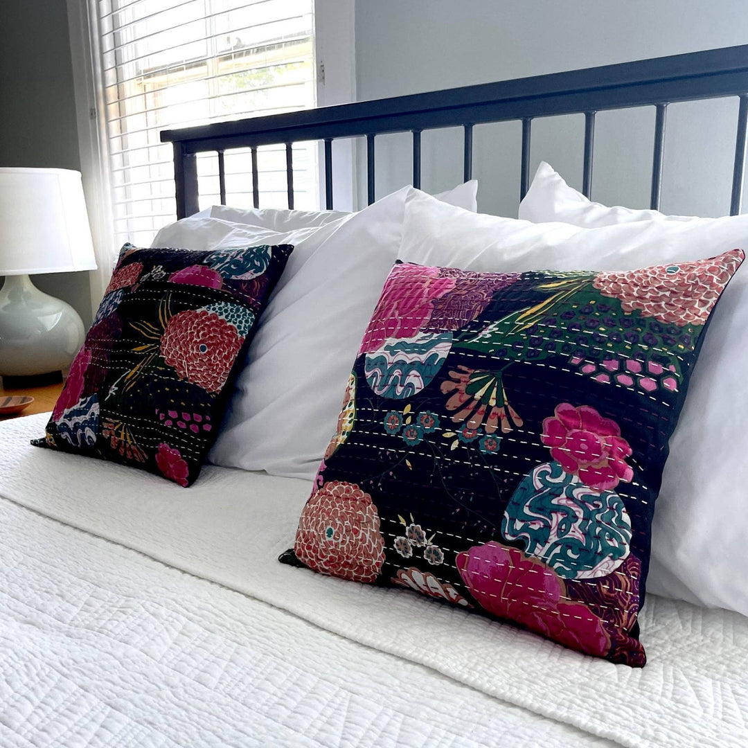 Night Lily kantha pillows on a bed with white bedding. 
