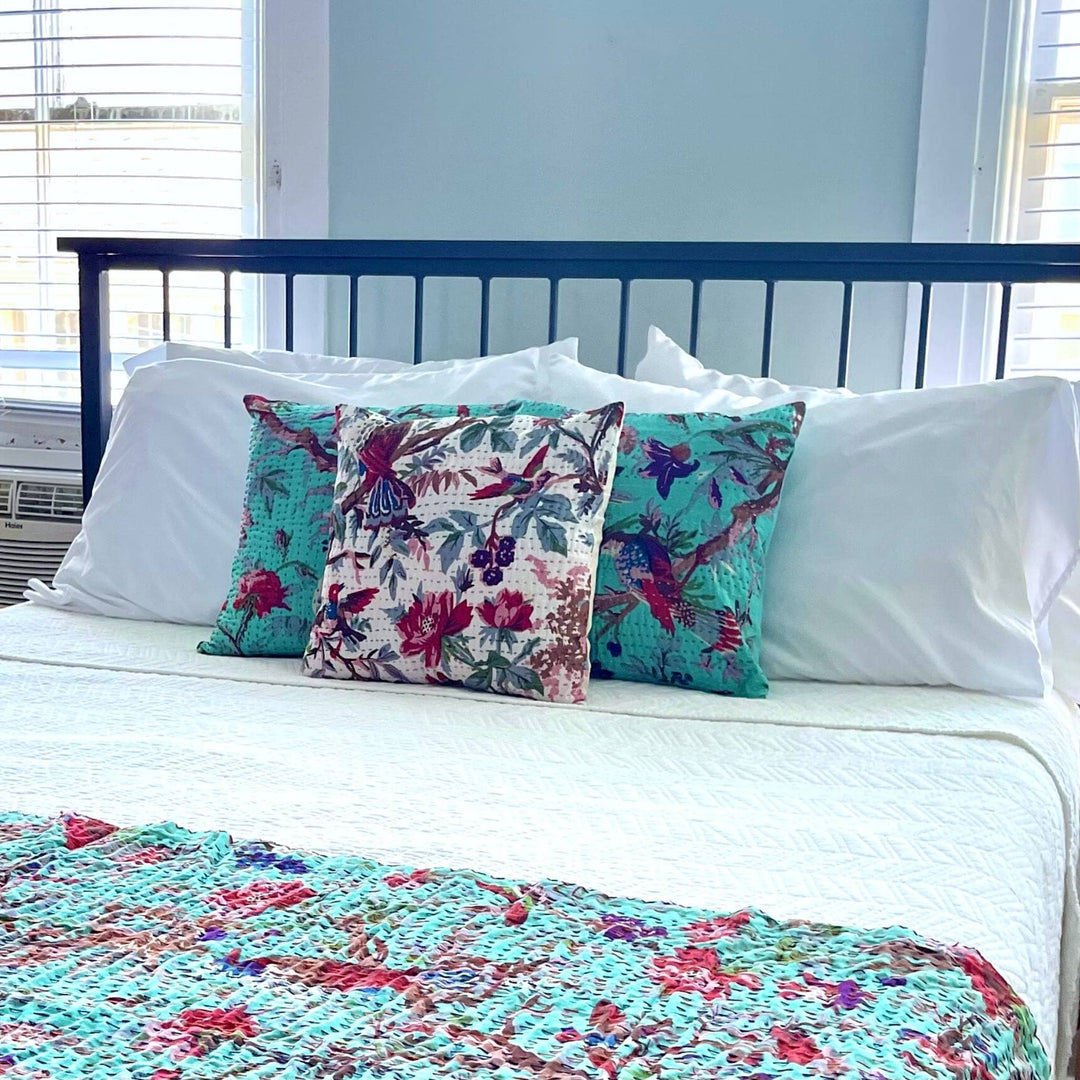 Robins egg  Kantha Quilt and Pillow Cover Set on a bed with white bedding. 
