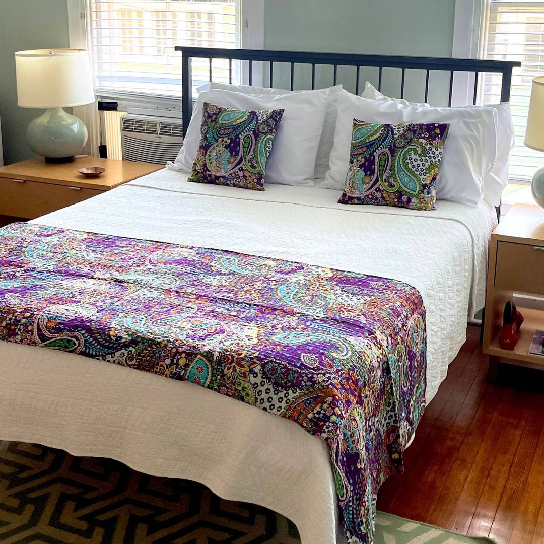 Paisley Fiesta Kantha Quilt and Pillow Cover Set on white bedding. 