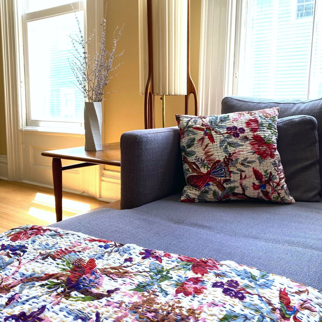 White Kantha Quilt and Pillow Cover Set on a grey couch. 