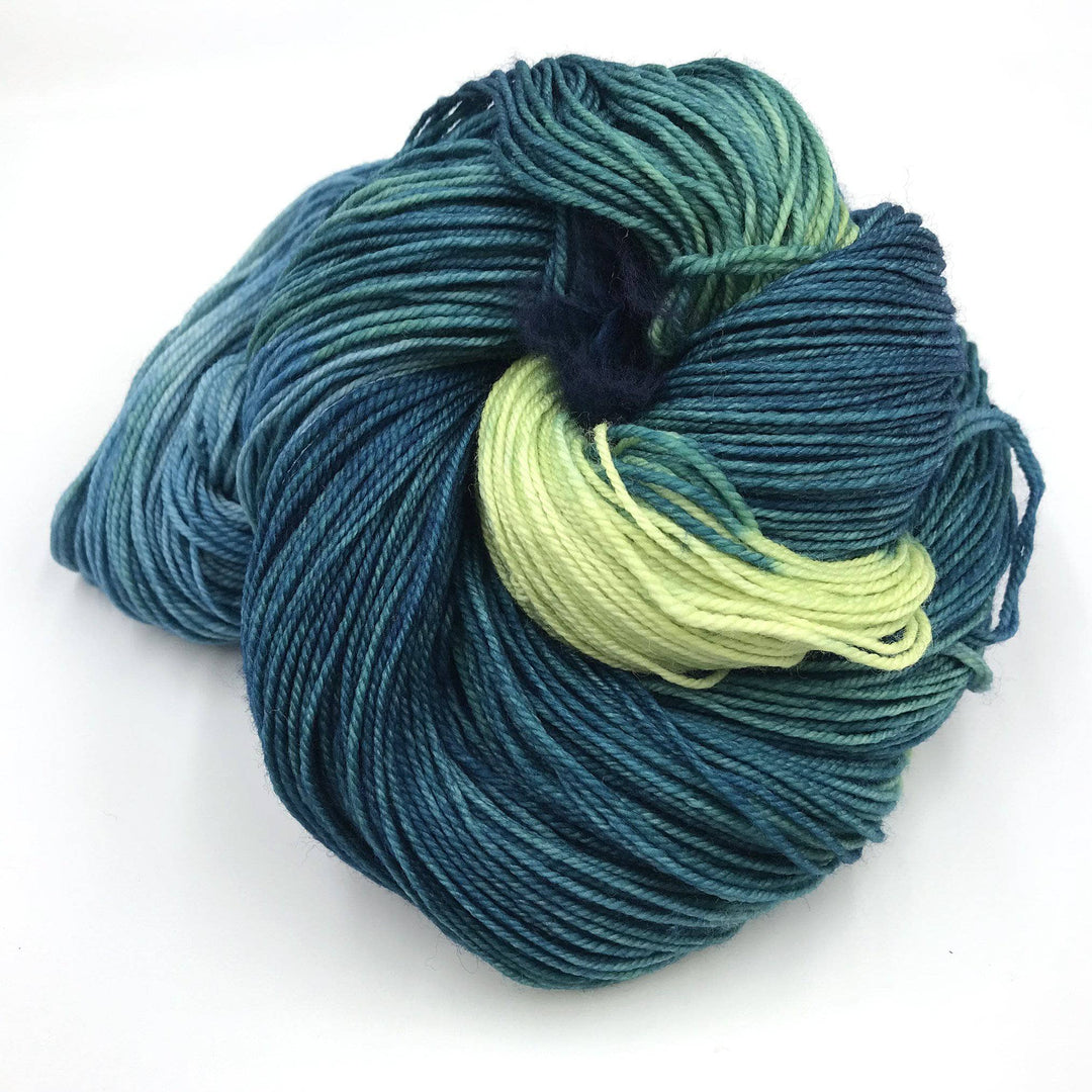 Superwash merino wool sock yarn ball in Juguito (teal) on a white background