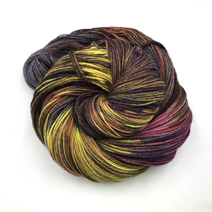 Superwash merino wool sock yarn ball in Splendor (brown, yellow) on a white background