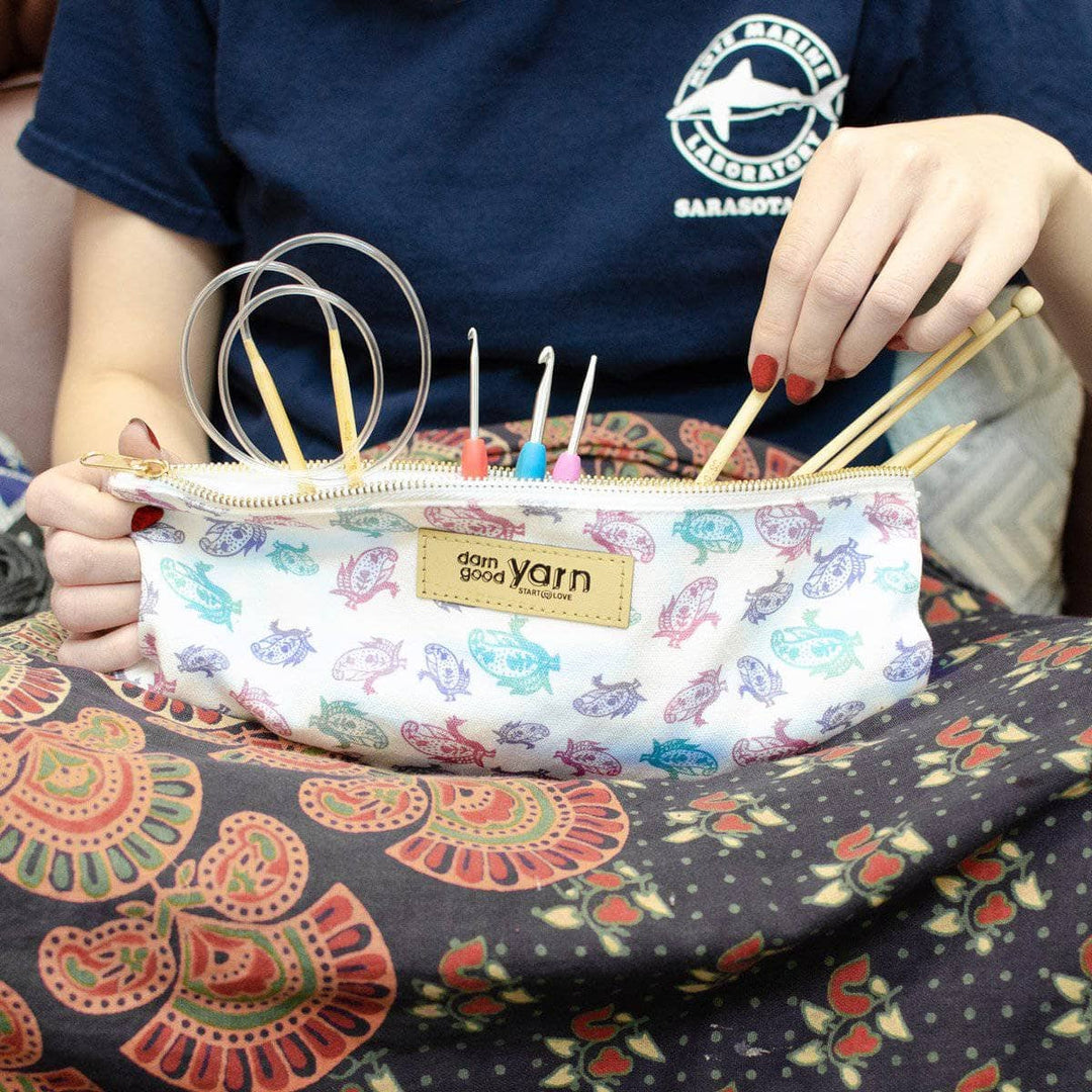 Model had the Paisley Knitting Needle & Crochet Hook Case sitting on their lap with crochet hook and knitting needles peaking out. 