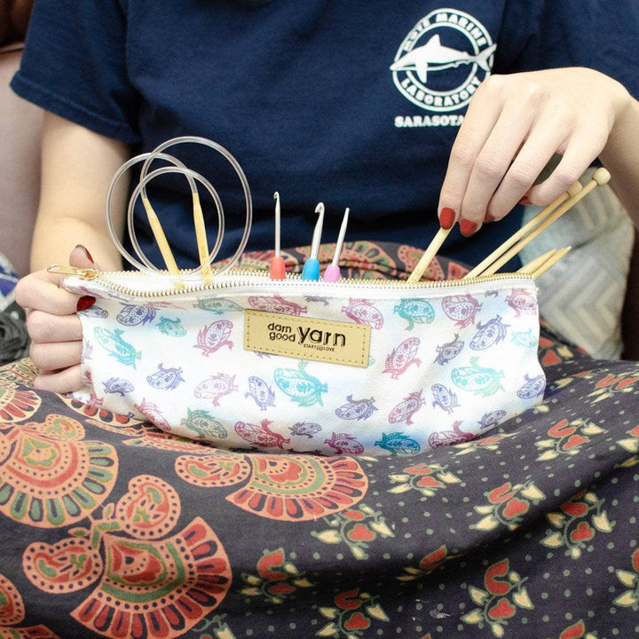 Model had the Paisley Knitting Needle & Crochet Hook Case sitting on their lap with crochet hook and knitting needles peaking out. 