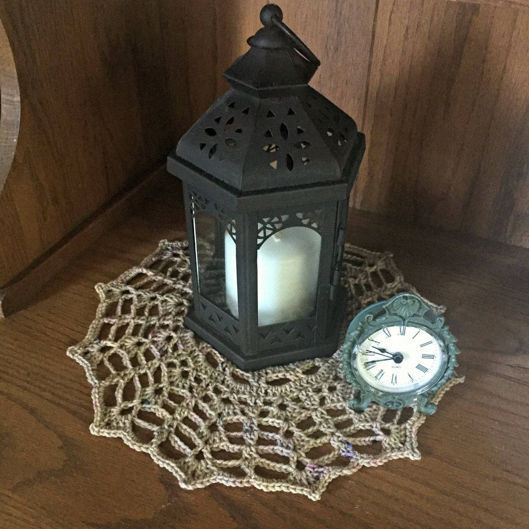 clock and candle over a table and a beige doily