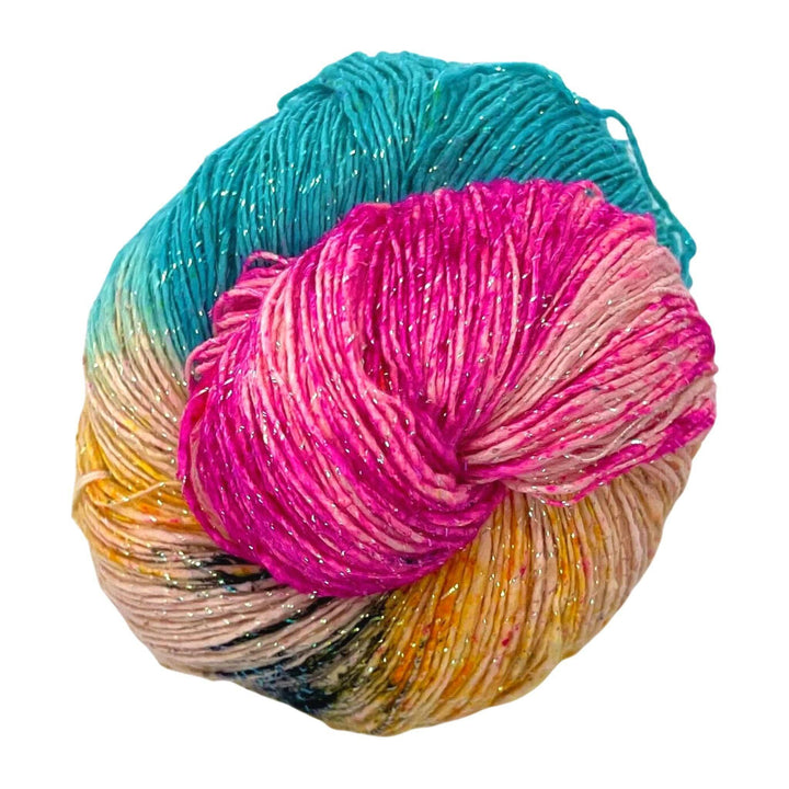 Pink, yellow, and blue yarn with black speckles in front of a white background.