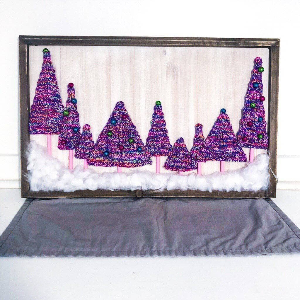 Purple yarn trees on a white background