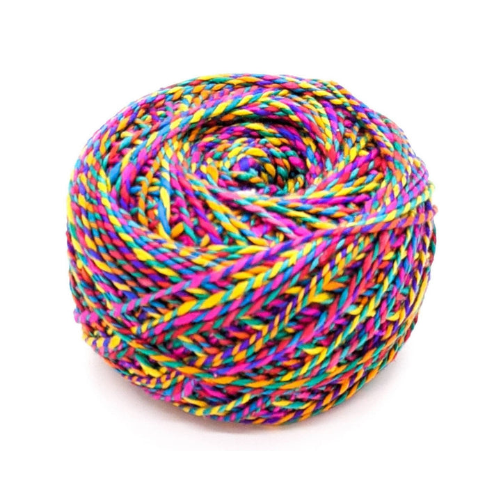 Darn good twist vibrant rainbow variegated yarn in front of a white background.