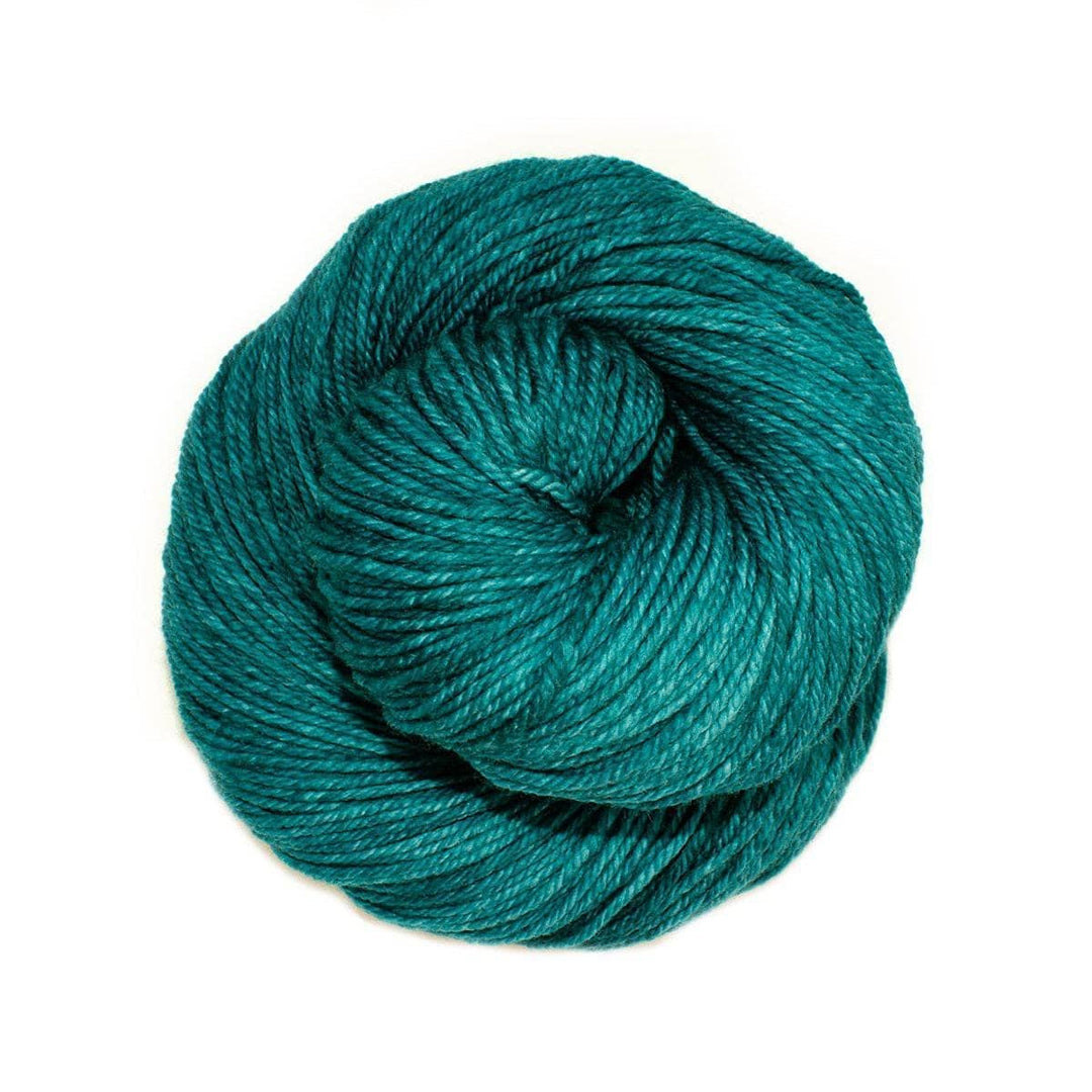 A skein of teal yarn on a white background