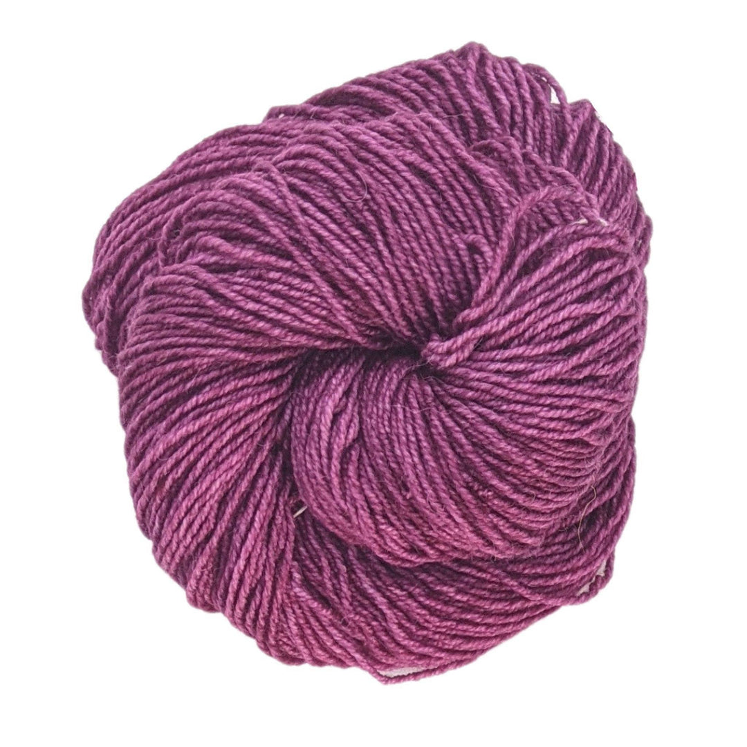 Skein of light purple yarn in front of a white background