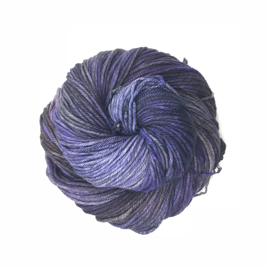 close up of a cake of yarn in the color lavanda (ombre purple)