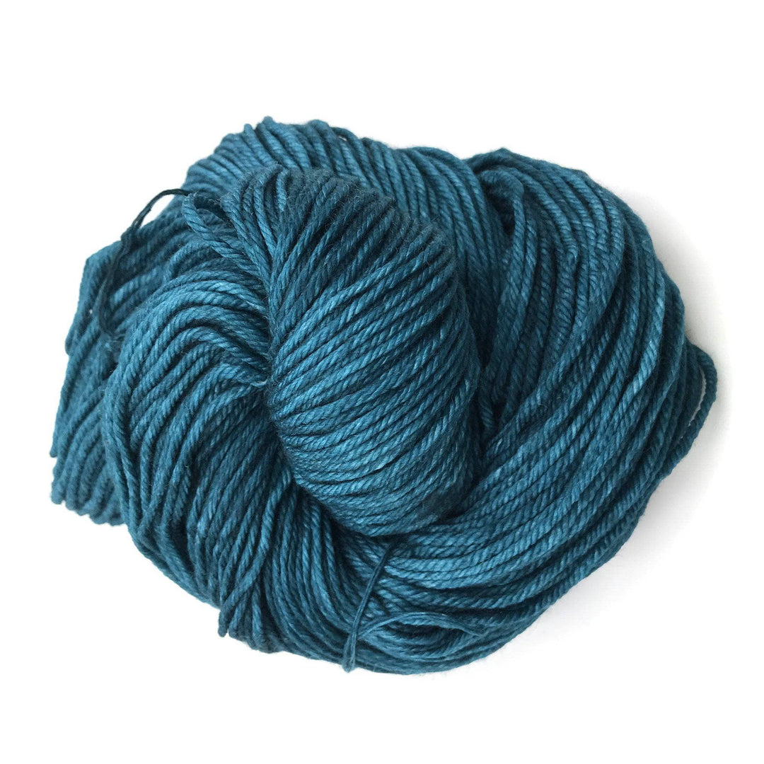close up of a cake of yarn in the color teal (teal feather)