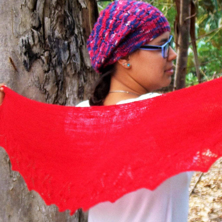 woman holding a bright red shawl
