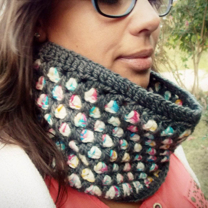 woman wearing a shawl with black with multicolored dots