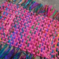 pink yarn mat sitting over the floor