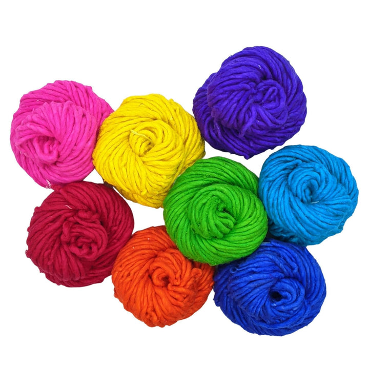 8 vibrant super bulky skeins reclaimed silk yarn in front of a white background.