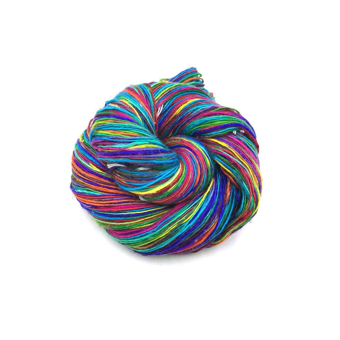 skein of single ply recycled lace weight silk yarn in the exotic rainbow colorway in front of a white background.