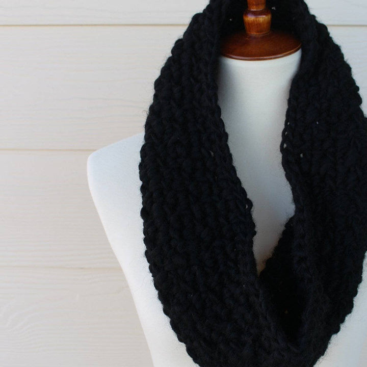 mannequin with a black scarf over a white background