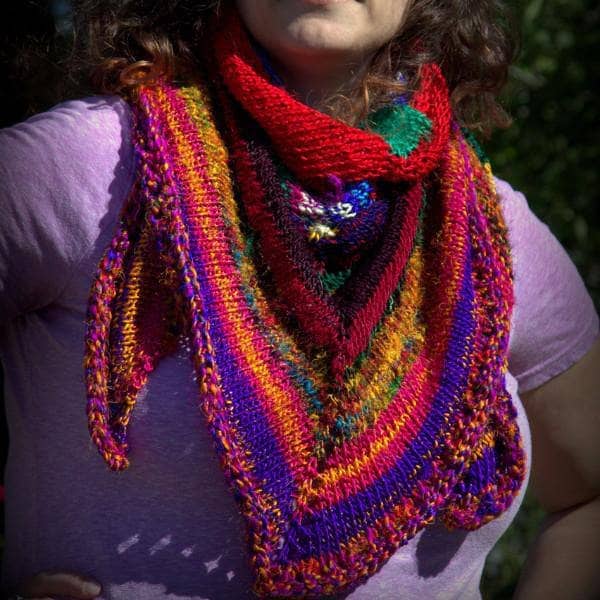  woman wearing colorful red yellow blue and brown shawl