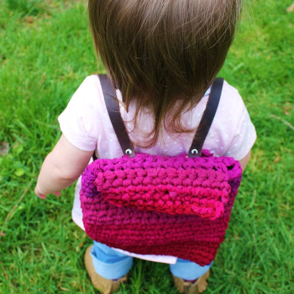 child with a purple bag