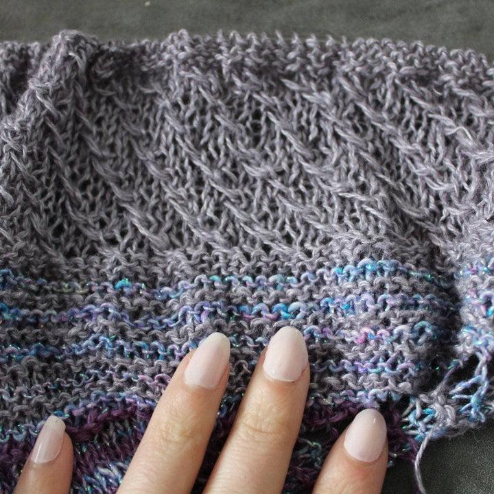 close up of fingers and a multicolored shawl