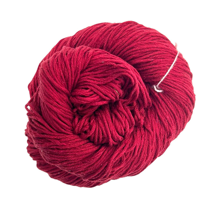 A skein of Mulberry silk fingering yarn in the colorway 'deep magenta' on a white background.