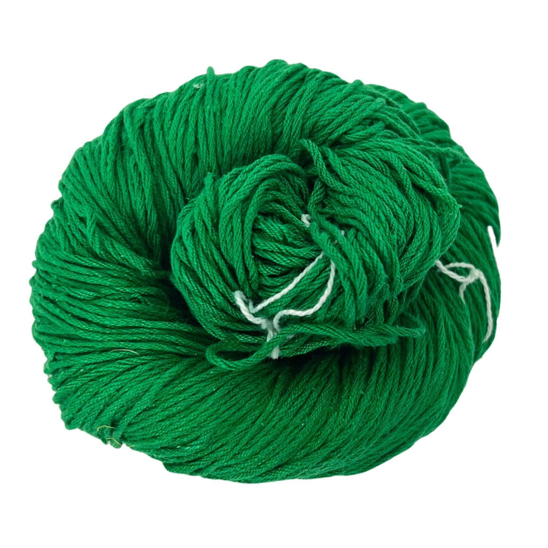 A skein of Mulberry silk fingering yarn in the colorway 'Jade' on a white background.