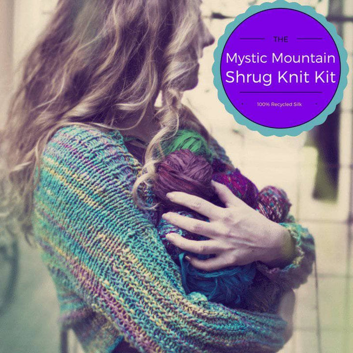 woman wearing a colorful Shrug and holding yarn