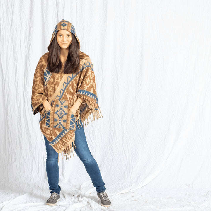 girl wearing Nanda Hooded Poncho on a white background
