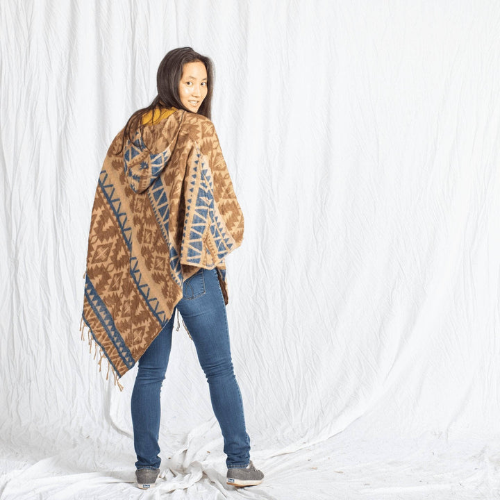 girl wearing Nanda Hooded Poncho on a white background