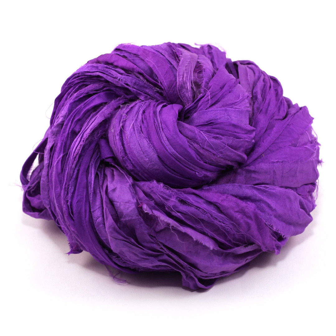 yarn cake in the color mercury purple with a white background