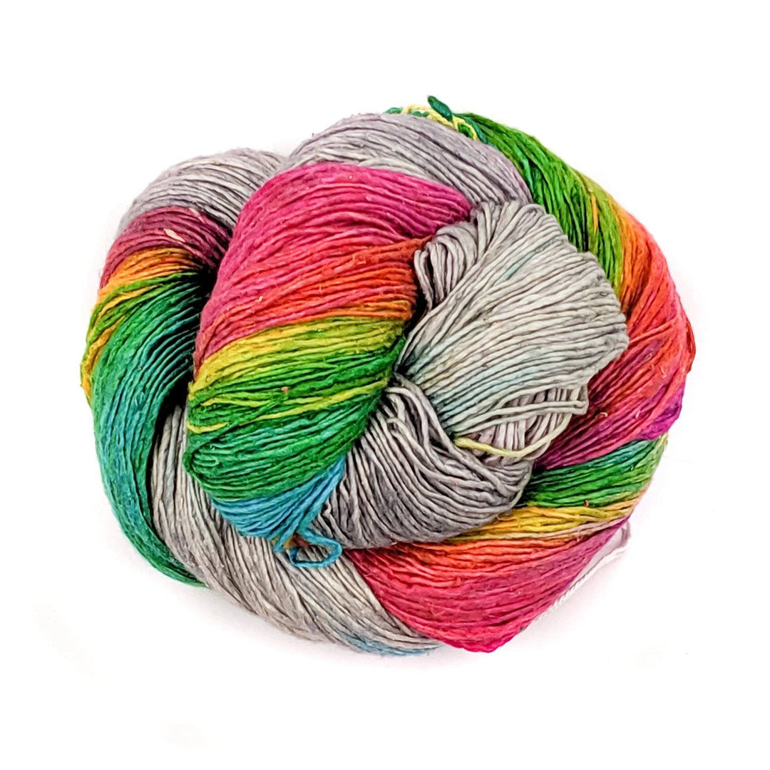 Grey and rainbow skein of yarn on white background